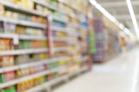 Supermarket blurred background fruit juice on shelves at grocery.